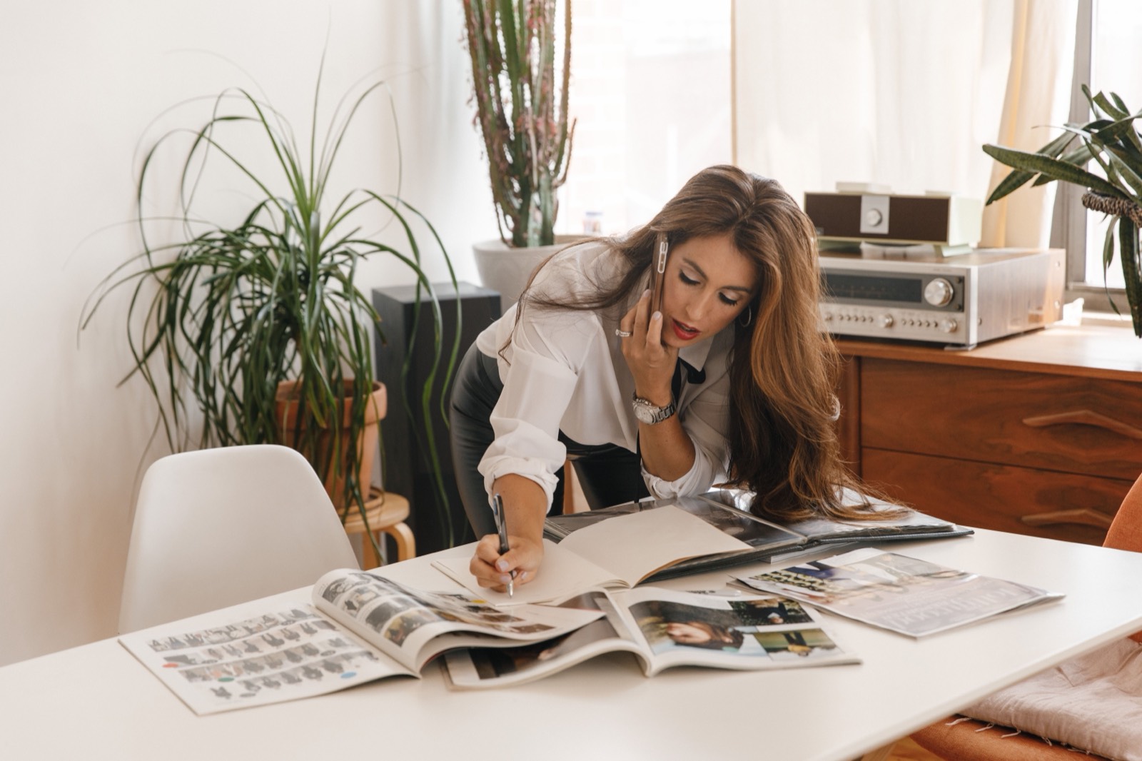 Small business owner working at a laptop, juggling day-to-day tasks